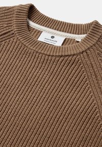 Maglione marrone a coste con scollo rotondo, caratterizzato da un'etichetta bianca al centro del collo e cuciture delle spalle estese e strutturate.