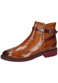 Bottine en cuir marron avec des détails en brogue, sangle et accent en boucle bordeaux, et semelle maroon contrastante. Fini lisse et bout rond.