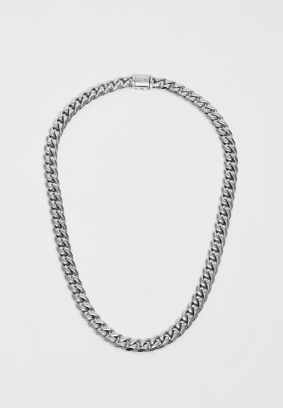 Silver-tone chain necklace with thick, flat curb links and a rectangular clasp engraved with a brand name on a white background.