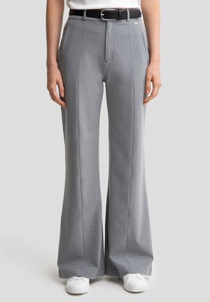Light gray, wide-leg trousers made of a textured fabric. Features pressed creases and a black belt with a rectangular silver buckle.