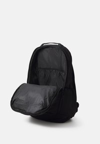 Black backpack with a zippered front pocket and spacious main compartment. Made of durable fabric, features internal pockets for organization.