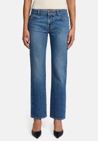 Jeans in denim azzurro chiaro con design a gamba dritta, caratterizzati da leggere scoloriture, cinque tasche e chiusura con bottone in vita.