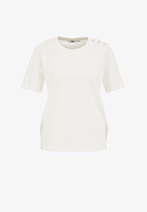 Biała bluzka z krótkim rękawem, okrągłym dekoltem i dekoracyjnymi guzikami na jednym ramieniu. Tkanina ma teksturowany wzór.