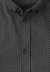 Camisa negra de manga corta con un patrón geométrico en gris oscuro, con un cuello abotonado y dos botones negros.