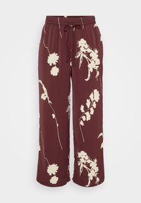 Pantalon marron à jambes larges avec imprimé floral crème, taille élastique et fermeture par cordon.