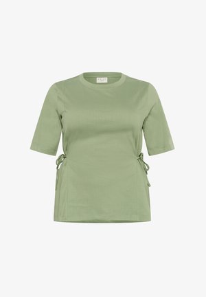 Haut vert à manches courtes en tissu doux, avec un col rond et des liens latéraux ajustables pour un ajustement personnalisable.