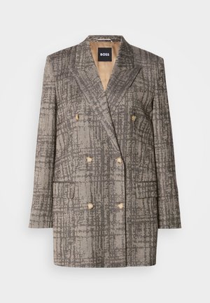 Blazer croisé en tissu gris texturé avec un motif à carreaux, doté de boutons marron clair et de revers.