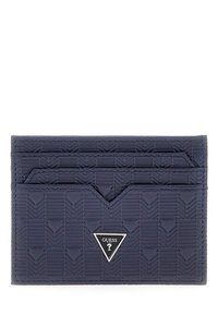 Porte-cartes bleu marine en matériau texturé avec un motif géométrique, doté de trois emplacements pour cartes et d'un accent de logo triangulaire.