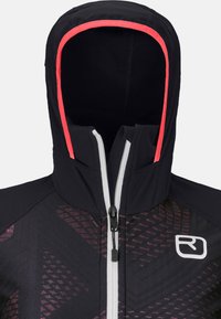 Black jacket with red accents, zip closure, and a hood. Features a textured design on the front with a logo on the chest.