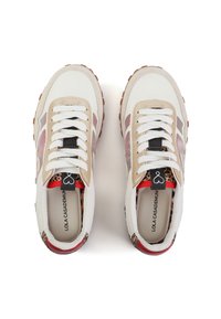 Zapatillas blancas y beiges con un forro de estampado animal, acentos de ante texturizado, cordones blancos y suelas de goma con un patrón de agarre marrón.