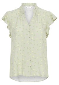 Helle grüne Bluse mit Rüschensäumen, floralen Mustern in Gelb und Lila, durchgehender Knopfleiste und abgerundetem Saum. Strukturierter Stoff.