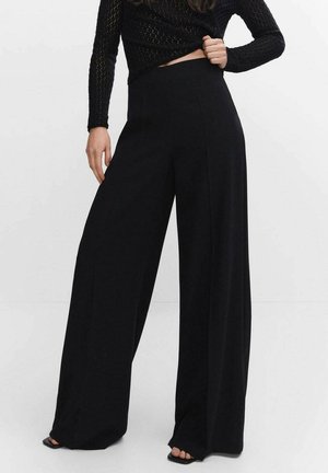 Pantalones negros de pierna ancha con cintura alta, hechos de una tela suave. Presentan un diseño limpio y una silueta fluida. Estilo simple y minimalista.