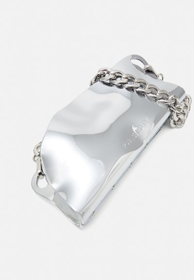 Metallic silver clutch bag with a curved design, featuring a chunky silver chain strap and prominent reflective surface.