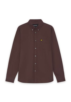 Brun langærmet skjorte lavet af bomuld med skrå krave, der har en enkelt brystlomme og et lille gult emblem.