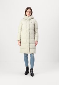 Light gray puffer coat with a hood, knee-length, featuring horizontal stitching, front zipper, and a subtle logo on the chest.
