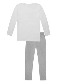 Chemise blanche à manches longues en coton avec un col rond, associée à un legging en coton gris avec une taille élastique.