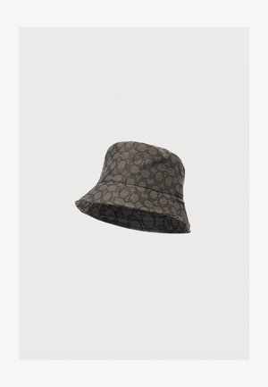 Tumehallist kangast nööbivatt, millel on ümmargune muster. Omab laia ja paindlikku äärt ning tekstureeritud pinda.