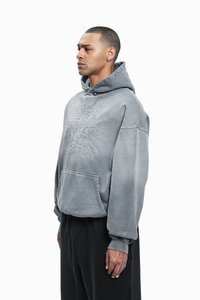 Gray hoodie with a large embroidered design on the front, kangaroo pocket, and drawstring hood. Soft material with a relaxed fit.