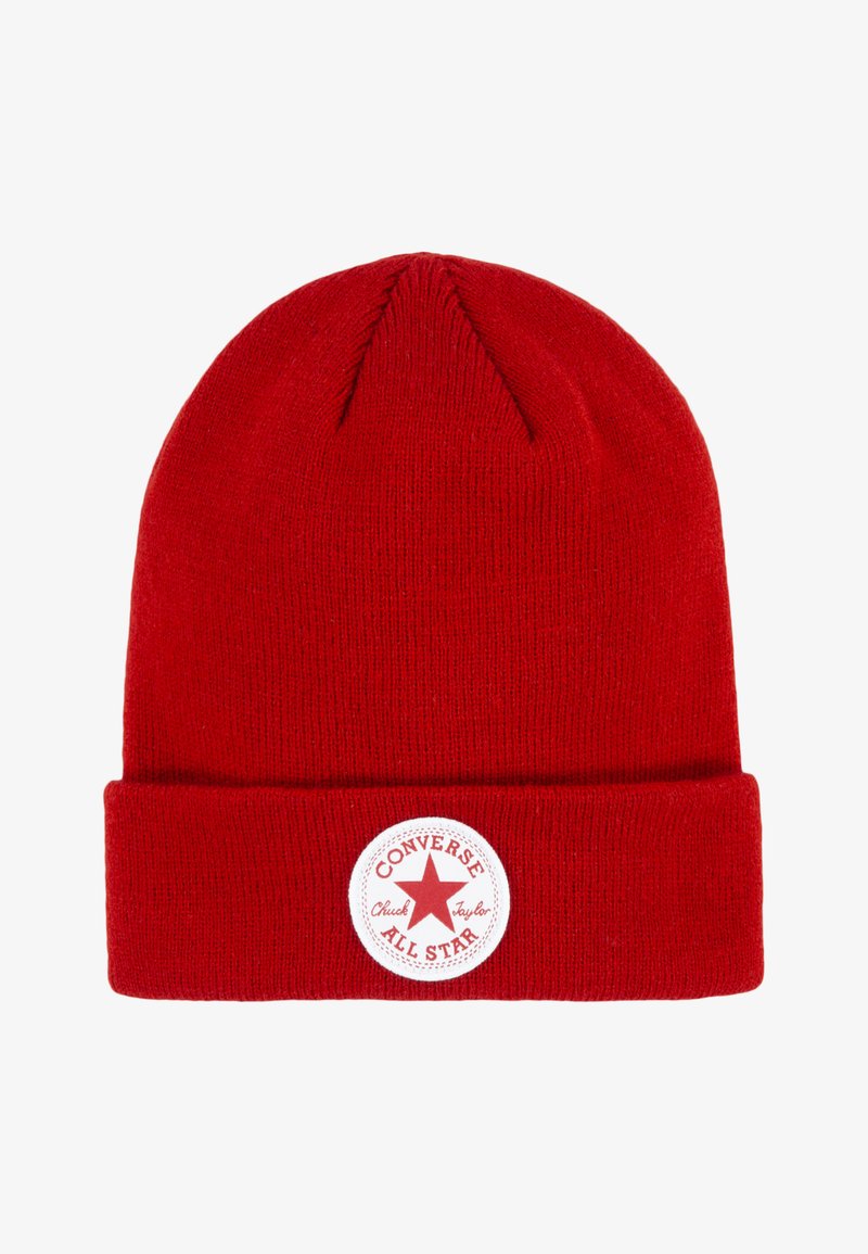 Red knit beanie with a folded brim, featuring a white circular patch with a red star and text "CONVERSE ALL STAR." Soft texture, standard shape.