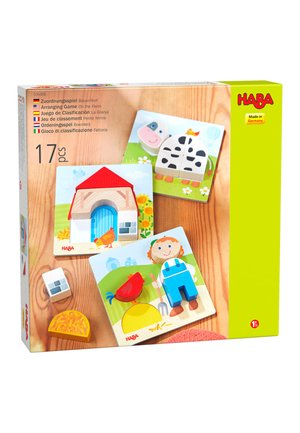 Wooden farm-themed puzzle pieces showing a cow, barn, farmer, chicken, hay, and stone on illustrated backgrounds.