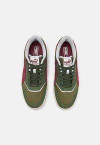 Green and maroon sneakers with suede and leather materials, featuring a perforated toe, padded collar, and white accents.