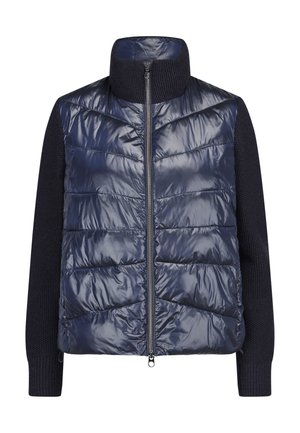 Navy insulated jacket featuring a quilted front, knit sleeves, high neckline, and a full zipper with a subtle shine. Textured fabric accents.