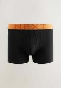 Fekete boxer alsónadrág narancssárga szőtt derékkal, amelyen vastag betűkkel a "NEXT" felirat szerepel. Puha jersey anyag, amely kényelmesen illeszkedik.