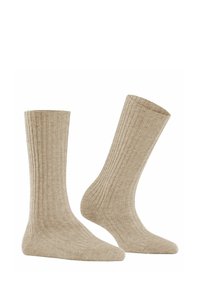 Beige ribbed socks made from a soft, textured fabric, featuring a mid-calf length and a seamless toe for comfort.