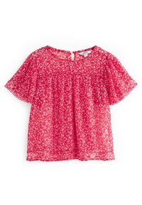 Blouse florale rouge en tissu léger et transparent. Dotée de manches courtes, d'un col rond et d'une fermeture éclair dans le dos.
