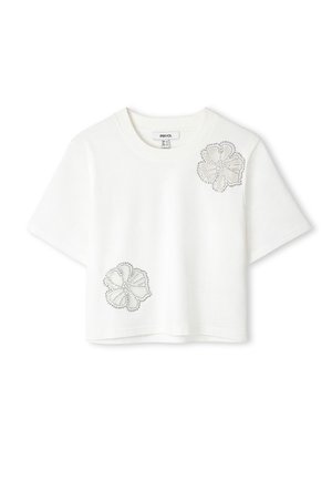 Camiseta corta blanca de algodón, con dos diseños de flores embellados con strass en la parte delantera. Mangas cortas y escote redondo.