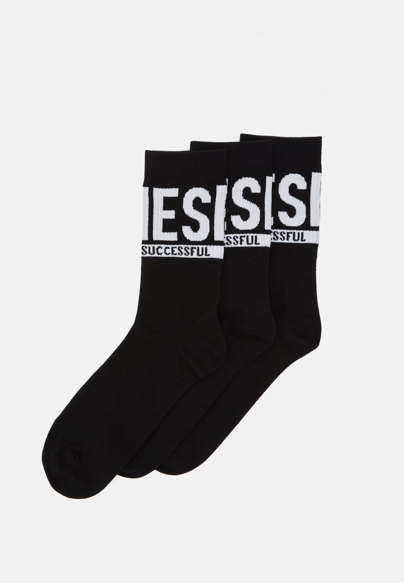 Calcetines de algodón negros, con el texto blanco "EXITOSO" en una banda horizontal en la parte superior. Textura suave con un diseño clásico.