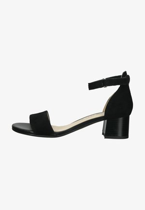 Sort ruskind hæl sandal med ankelrem, åben tå og block heel. Glat tekstur og minimalistisk design.