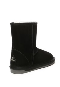 Black suede ankle boot with white fur lining, stitched accents, and a rubber sole. Features a logo on the side for brand identification.