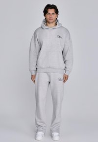 Gray hoodie and sweatpants set made from soft fabric; features a front pocket, ribbed cuffs, and logo embroidery on the chest and leg.
