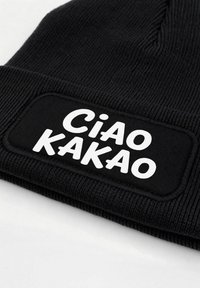 Black knit beanie featuring a textured fabric and a white rectangular patch with the words "Ciao Kakao" in bold font.
