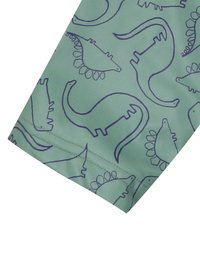 Tissu vert clair avec un motif répétitif de silhouettes de dinosaures en bleu marine. Présente une texture lisse et des bords cousus.