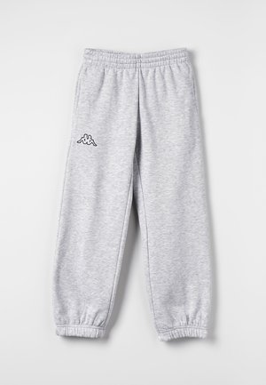 Pantalon de survêtement gris clair avec taille et chevilles élastiques, avec un petit logo noir et blanc sur la cuisse gauche.