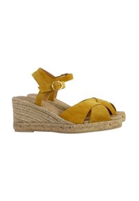 Yellow suede wedge sandals with a braided jute platform, featuring an adjustable ankle strap and open toe design.