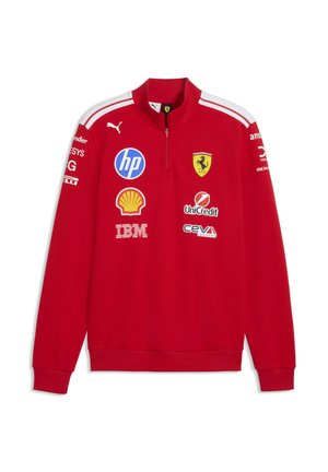 Czerwony długi rękaw bluza Ferrari z białymi paskami na ramionach, kołnierzem na zamek oraz logo sponsorów, w tym HP, Shell, IBM, UniCredit i Puma.