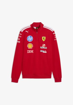 Red long-sleeve Ferrari pullover with white stripes on shoulders, zipped collar, and sponsor logos including HP, Shell, IBM, UniCredit, and Puma.