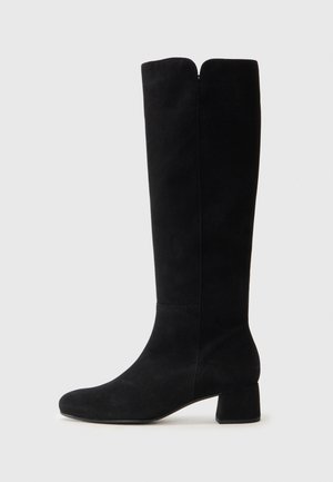 Black suede knee-high boot with a round toe, low block heel, and a distinctive cutout at the top, featuring smooth texture and minimal stitching.