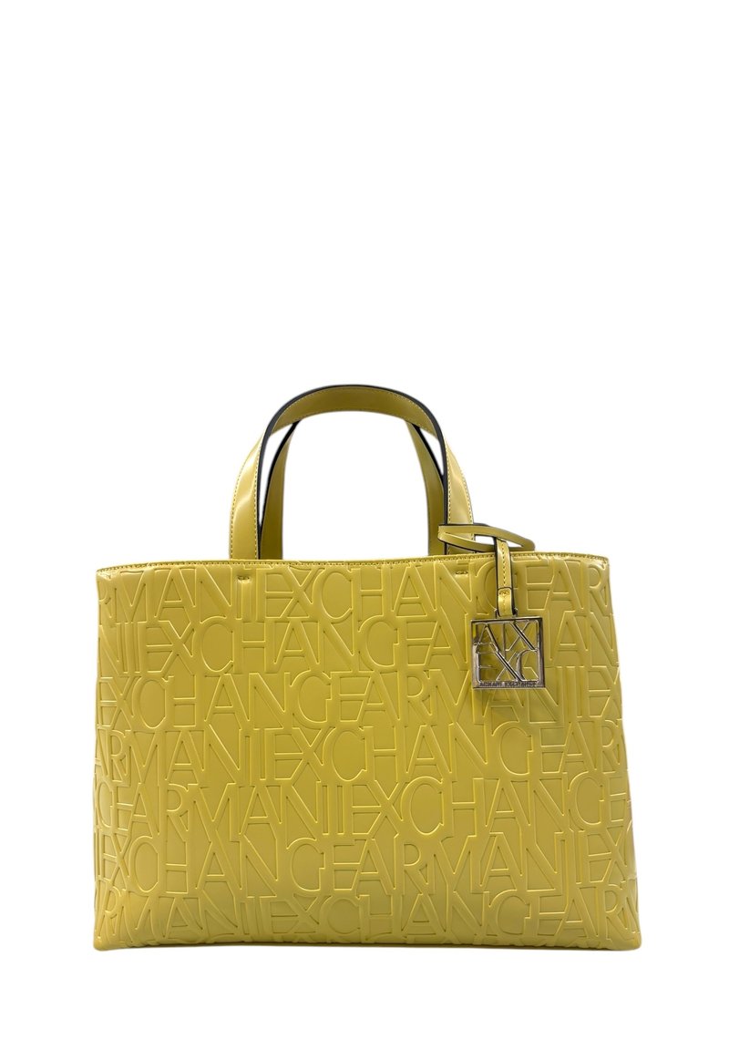 Borsa a spalla in pelle gialla decorata con la parola "Exchange", con dettagli neri e un'etichetta in metallo argentato attaccata a un manico.