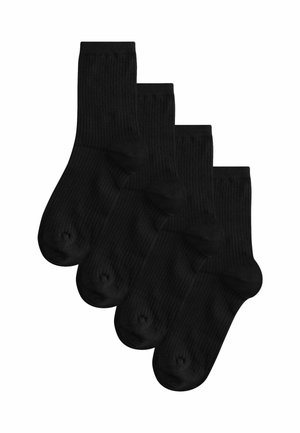 Black ribbed socks, layered, featuring a crew length design with smooth texture and reinforced toe areas. Set of four pairs.