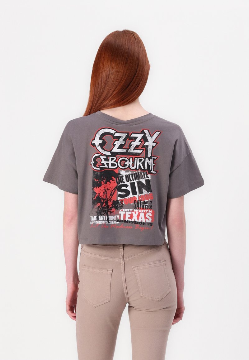Gray cropped t-shirt featuring Ozzy Osbourne graphic in red and black with tour details. Short sleeves and relaxed fit. Seamless back.