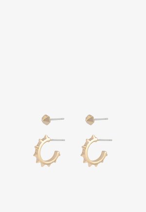 Øreringe i guldfarvet tone med et ørepuffedesign med pigge og en stiftlåsning. Glat metalfinish med et geometrisk nierstop.