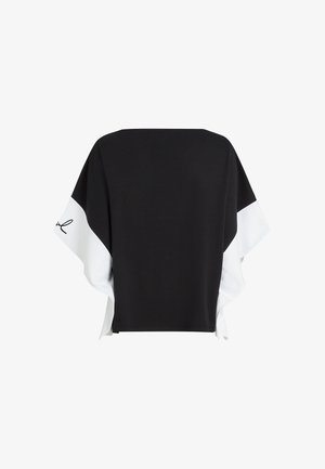 Schwarzes und weißes locker sitzendes Oberteil mit weiten Ärmeln, das ein weißes Paneel und einen kursiven Text auf dem linken Ärmel aufweist.