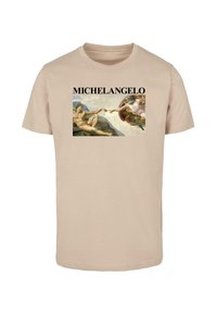 Beige cotton t-shirt featuring a graphic of Michelangelo's artwork with the text "MICHELANGELO" in bold black letters above the image.