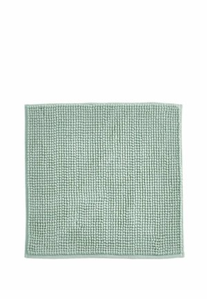Alfombrilla de baño de textura suave color verde claro con pequeños lazos redondeados dispuestos en un patrón de cuadrícula y bordes ribeteados.