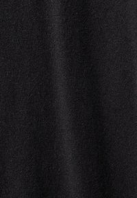Tessuto in maglia nera che presenta una finitura morbida e testurizzata. Il materiale appare leggermente elasticizzato con filamenti uniformi e lisci.