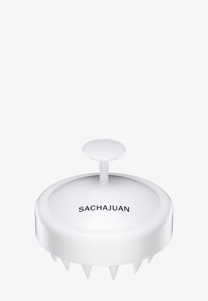 Hvid hovedbundsmassager med et glat, rundt design og et centralt håndtag. Har seks korte pigge til blid stimulering. Brandnavn synligt.